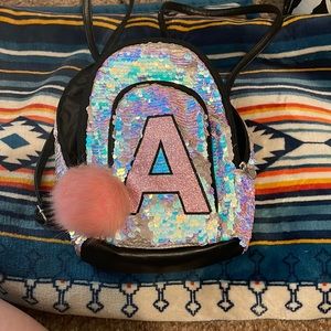 Justice mini backpack with an A bought for 35 selling for $15!